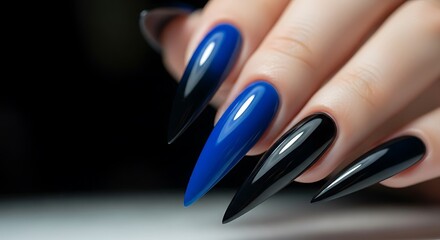 Beautiful glossy blue and black stiletto manicure.