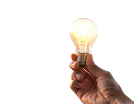 A person's hand firmly grasps a glowing, incandescent glass bulb against a dark, contrasting background. Light emanates from within