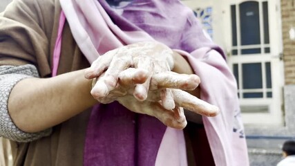Closeup footage of hands washing with soap to clean hands from germs and infection. A girl washing her hands before taking meal promoting healthy life. A woman cleaning her hands after work.