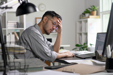 Naklejka premium Businessman looking stressed from work, Businessman working at office feels overworked and burnout