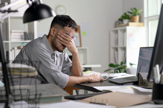 Businessman looking stressed from work, Businessman working at office feels overworked and burnout