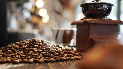Aromatic roasted coffee beans piled next to a vintage wooden coffee grinder Warm blurred cafe background with soft bokeh and steam perfect for a cozy morning - Powered by Adobe