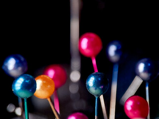 Vibrant array of colorful round-headed pins create a whimsical and playful composition.