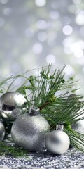 Silver christmas ornaments with pine needles and glitter