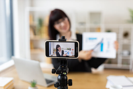 Caucasian woman recording business presentation, sharing strategies and data analysis from laptop setup