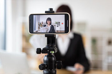 Caucasian woman recording financial literacy video showcasing cash, providing investment tips,...