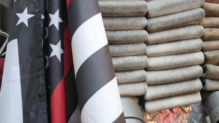 Red thin line black american flag on firefighter truck. Hose of firetruck and fire fighters symbol in New York, United States. 911 remembrance, fire department engine vehicle. September 11 Patriot Day - Powered by Adobe