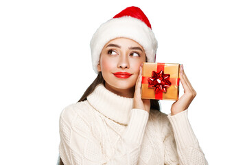 Beautiful woman in a white knitted sweater and santa hat with gift box isolated on transparent...