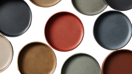 Assorted earthy-toned plates, round, arranged on black