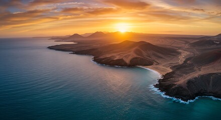 Aerial view of a coastline bathed in golden sunlight during a sunset. Majestic landscape