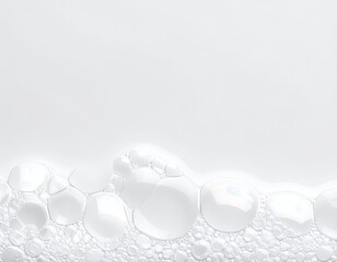 Bubbles cascade across a white, neutral surface
