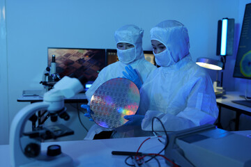 Technician working on analyzing semiconductor or microchip boards, electronics industry, electronic...