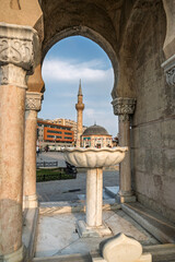 The Yalı Mosque seen from between the feet of the Izmir Clock Tower