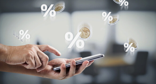 Using smartphone for online banking and checking interest rates, digital finance concept for smart technology, business investment, and modern money management in the digital era.