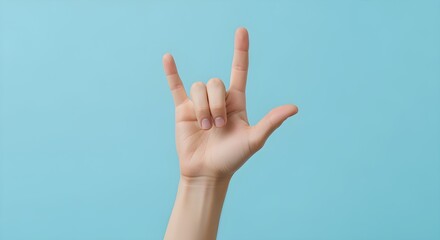 Fototapeta premium A dynamic hand gesture on a bright blue background, conveying a sense of unity, passion, and popular culture expression, perfect for modern visual communication