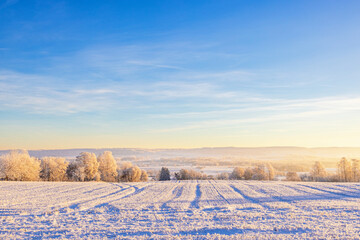 Wintry landscape view from a field at a valley a cold winter day