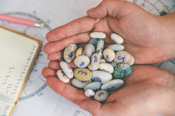 Numerology and divination with number stones in hands. Esotericism