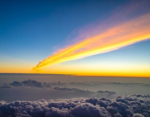 Aerial view of vibrant sunrise, golden clouds above a sea of fluffy clouds at dawn
