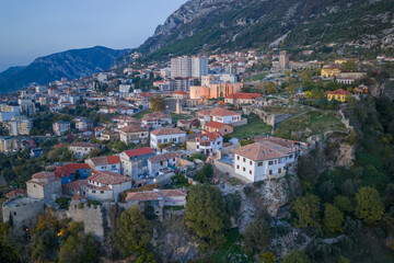 Fototapeta premium Twilight aerial of Kruja’s fortress with the Skanderbeg Museum and old town houses blending into the mountain slopes.
