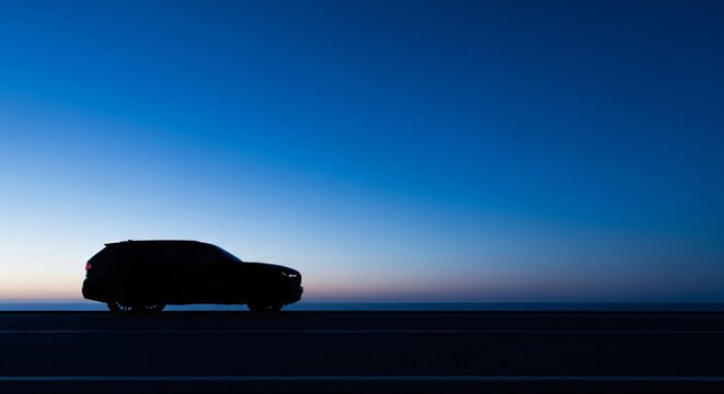 SUV Silhouette on Horizon at Twilight perfect for website banner, editorial content, automotive advertising, travel blog