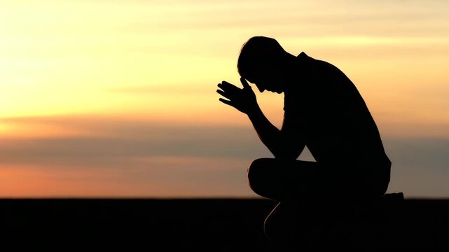 Silhouette of a Person Praying at Sunrise, Peaceful Spiritual Moment (4K)