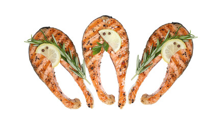 three perfectly grilled salmon steaks garnished with lemon, fresh rosemary sprigs, and mixed...