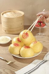 Traditional Chinese Steamed Pumpkin Buns with Chopsticks and Bamboo Steamer Basket