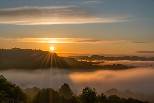 Stunning sunrise over misty mountain range with golden light creating a serene, beautiful landscape - Powered by Adobe