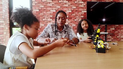 Happy kids celebrate success in a robotics classroom, high-fiving their teacher after completing a STEM coding project. Diverse group with teamwork and innovation spirit in educational tech learning. - Powered by Adobe