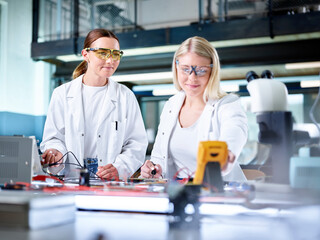 Smiling scientists working in laboratory