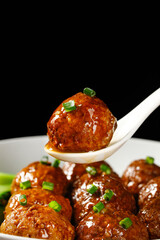 Glazed Pork Meatballs with Green Onions on White Spoon - Asian Cuisine Food Photography
