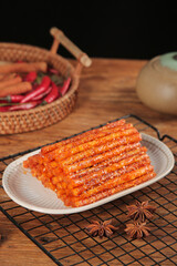 Spicy Weilong Gluten Strips Asian Snack Food with Chili Peppers and Star Anise on Wooden Table