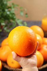Fresh Navel Orange in Hand - Sweet Citrus Fruit Display