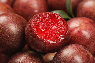 Fresh Chilean Red Plums Cut Open Showing Juicy Crimson Flesh Close-Up
