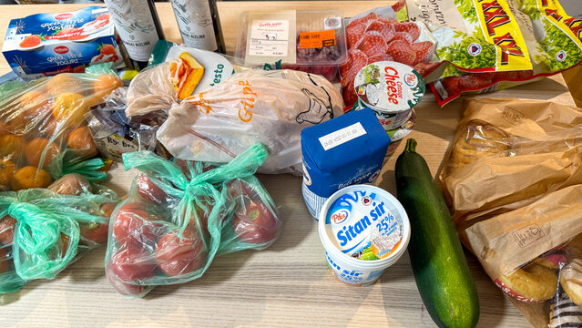Assorted groceries vibrantly spill across a wooden table, evoking the bustling spirit of Serbian Slava with Balkan pantry essentials June 5, 2025, Beograd, Serbia
