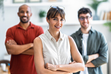 Confident team members at startup office smiling at camera