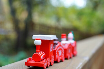 A small toy train in a city park. Christmas tree toys.