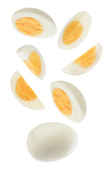 dynamic composition of hard-boiled egg slices and segments floating in the air, highlighting the firm white and rich golden yolk, isolated on black.