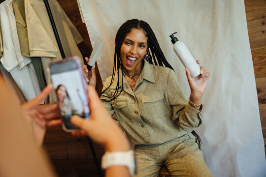 Woman showcasing product during a social media content creation photo session