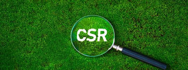 Magnifying glass with CSR goals for society and the environment