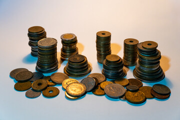 Stacked and scattered coins representing global finance and savings