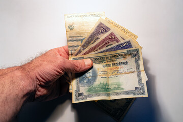 Hand holding old spanish pesetas banknotes collection
