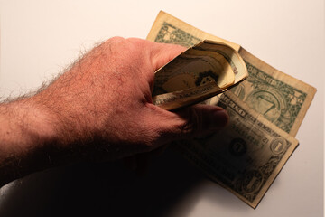 Hand holding old one dollar bills cash economy