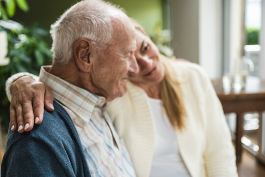 Woman embracing father and spending time together at home