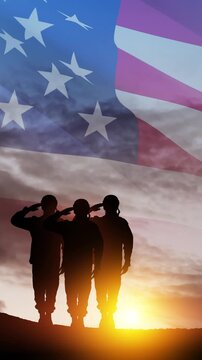 Silhouettes of soldiers saluting on background of sunset or sunrise and USA flag. Veterans Day, Memorial Day, Independence Day. Vertical video for social media and stories.