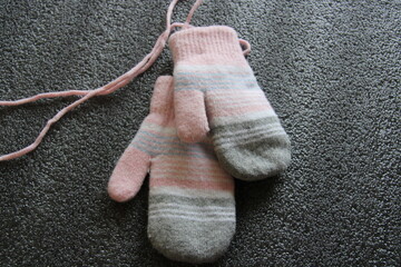 pink mittens on a black background,