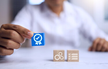 Quality assurance concept with a man show a certified mark on wooden block represent to products...