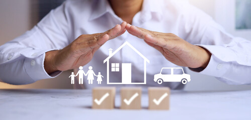 insurance concept with man in white using two hand to protect the family represent to coverage...