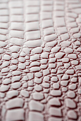 Shiny red leather surface with shallow depth of field