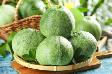Fresh Sweet Green Melons from Shandong China on Bamboo Plate with Wicker Basket Display